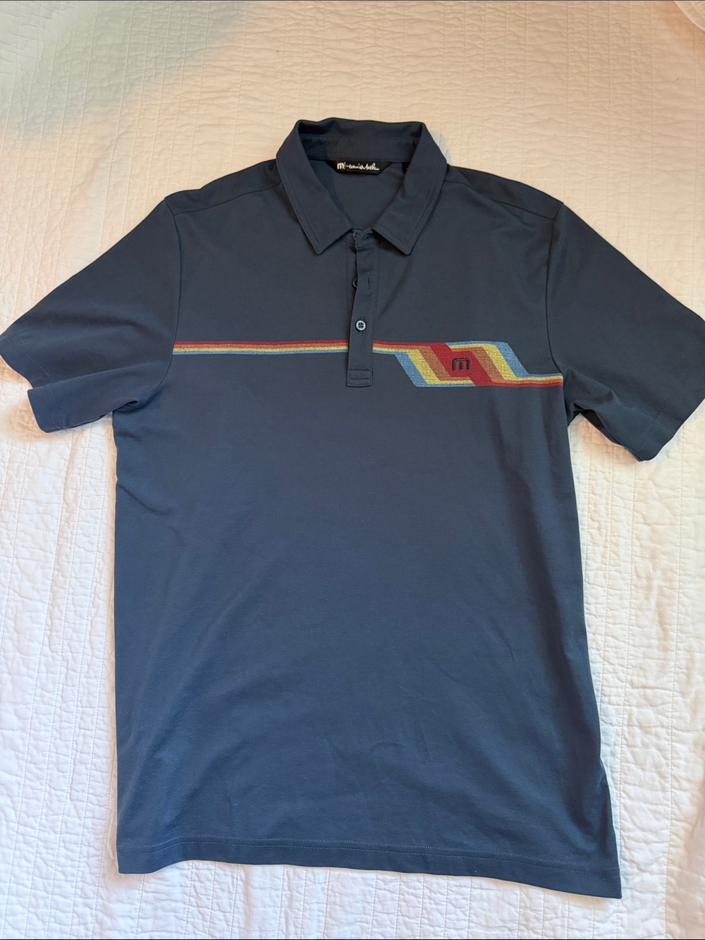 Travis Mathew Navy Polo with Multicolor Retro Stripe